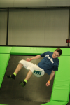 Man Flipping about to Land on Trampoline